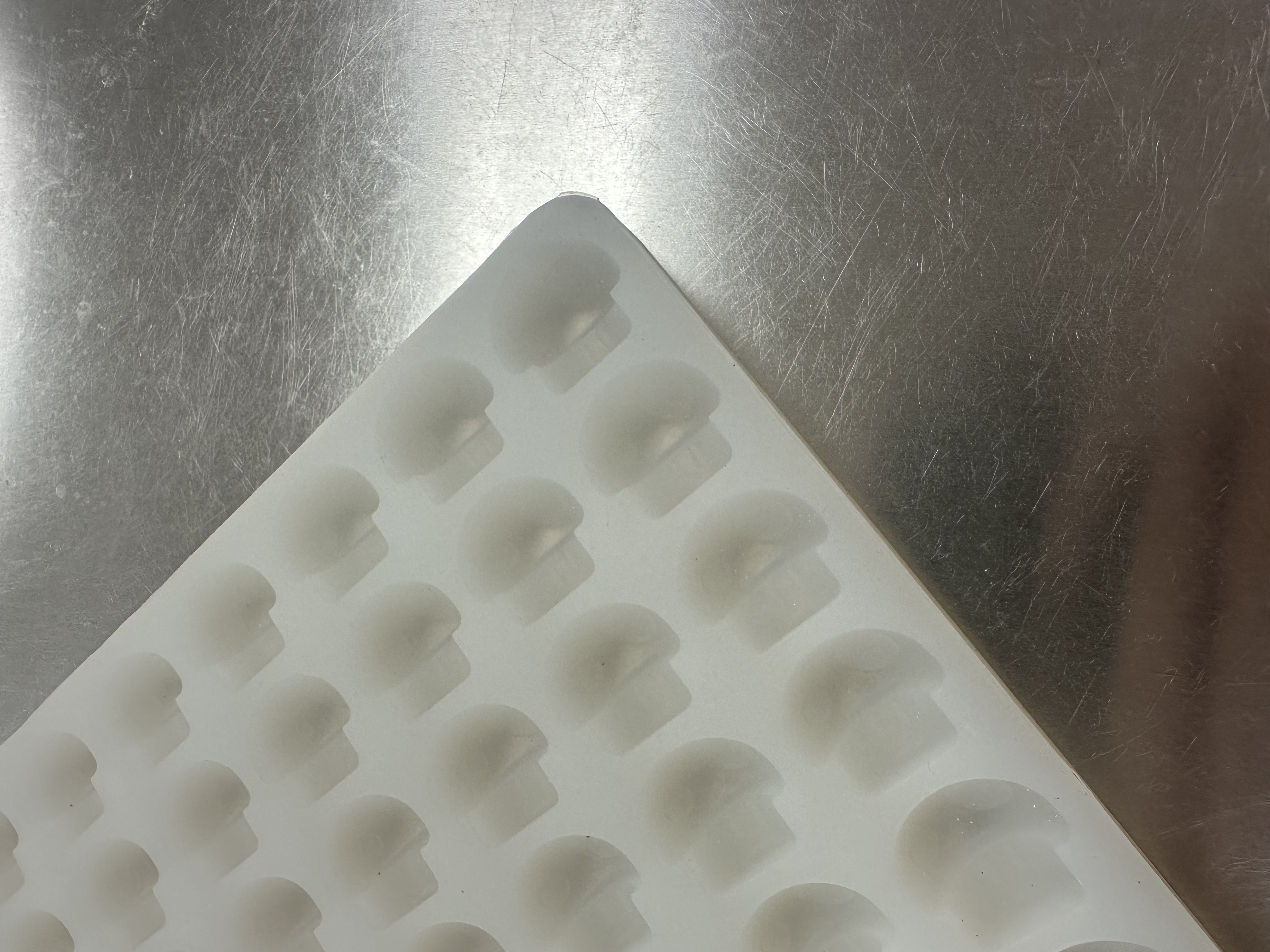 Angled close-up of mushroom-shaped cavities on Product 013